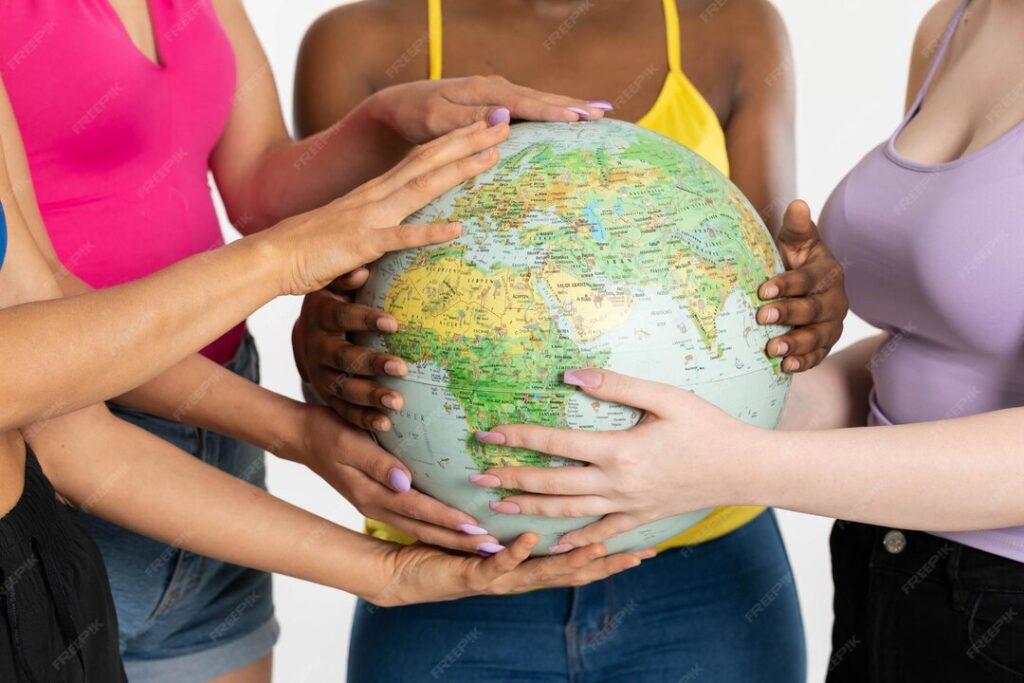 four women hold globe front them gently embrace it with their hands 357949 6528